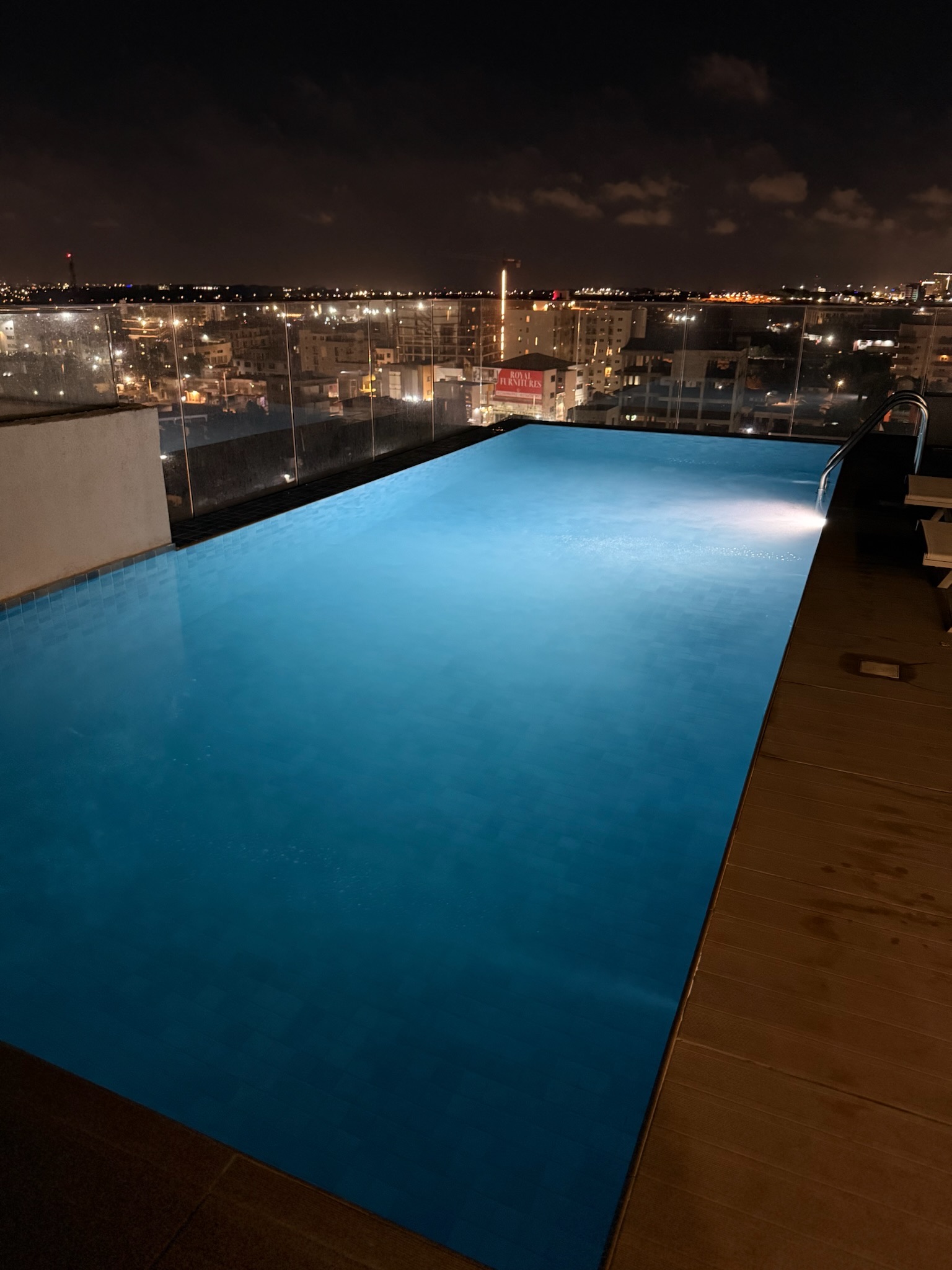 Arlington Court rooftop pool at night, Accra